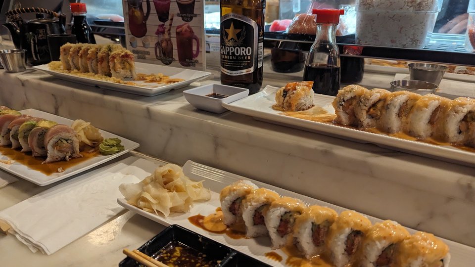 A sushi restaurant interior with table service.